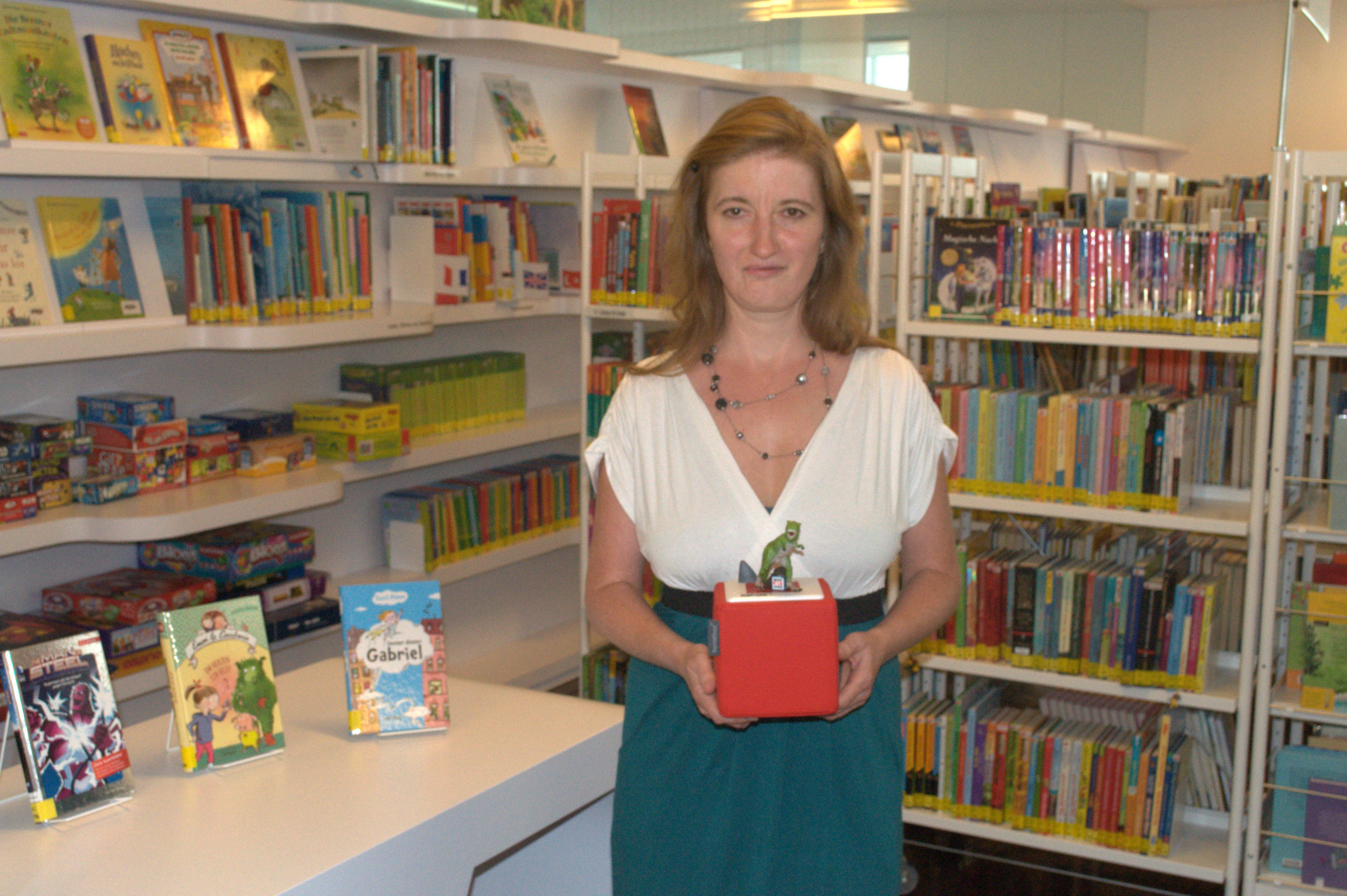 Berit Dietsche, Leiterin der Mediathek Oberkirch, hält eine Tonie-Box mitsamt Dinosaurier-Figur in ihren Händen.