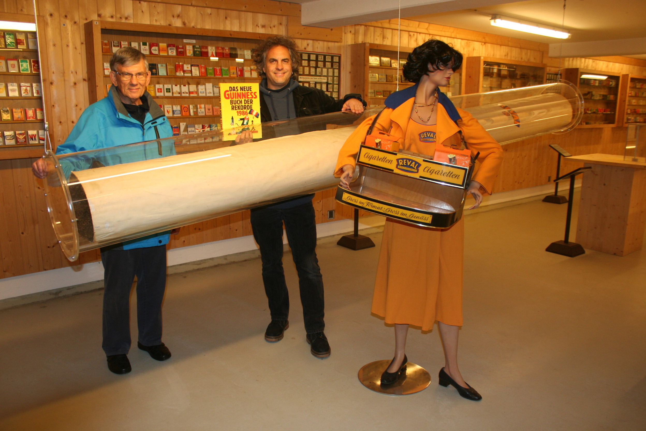 Die weltgrößte Zigarette hat eine neue Acrylhülle bekommen – links Museumsleiter Patrick Benz, rechts Förderkreis-Vorsitzender Wolfgang Ohnemus