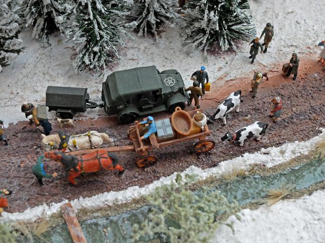 Diorama, das eine winterliche Szene gegen Ende des zweiten Weltkrieges darstellt. Die Landbevölkerung ist mit Sack und Pack auf der Flucht, vor dem bevorstehenden Angriff der amerikanischen Truppen, gegen deutsche Stellungen. Die Figuren und das Pferdegespann (Maßstab 1:87) sind von der Firma Preiser und der amerikanische Dodge WC 58 von der Firma Rocco. | Foto: Alfred Schramm