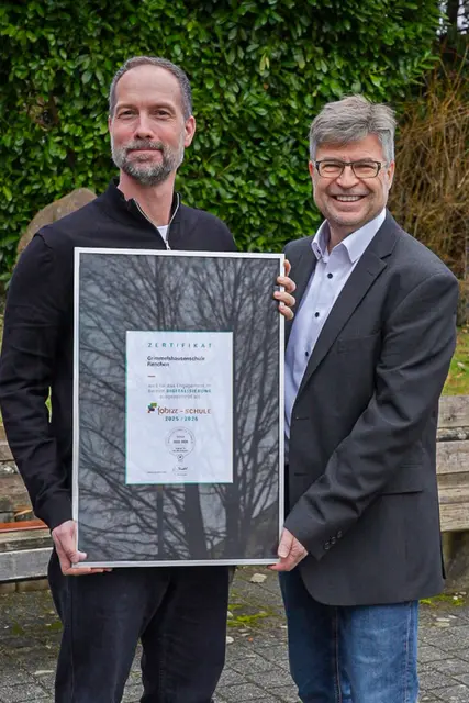 Rektor Ralf Meier (r.) und IT‑Fachkraft Sascha Graab präsentieren die Auszeichnung „fobizz"‑Schule für die Grimmelshausenschule Renchen.  | Foto: Grimmelshausenschule Renchen